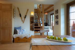 a room with a table with a plate of fruit on it at Apartamenty Tatrzańskie Turnie in Zakopane