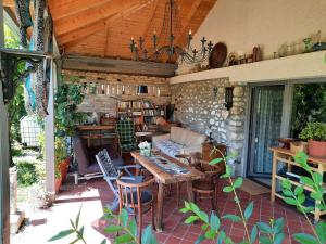 a patio with a table and chairs and a stone wall at Patak Apartman, Diszel in Tapolca