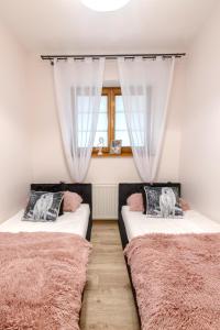 Postel nebo postele na pokoji v ubytování Apartamenty Tatrzańskie Turnie