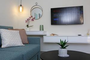 a living room with a couch and a table at Under the Aqueduct boutique house in Kavála
