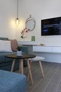 a living room with a table and a couch at Under the Aqueduct boutique house in Kavála