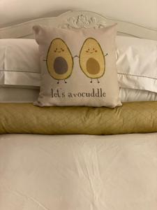 a pillow with two birds on it on a bed at Cockfosters executive Mews in Barnet
