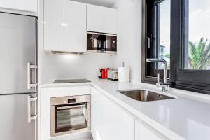 A kitchen or kitchenette at by RIVA - Chic, Contemporary Studio in Puerto Banus Gardens