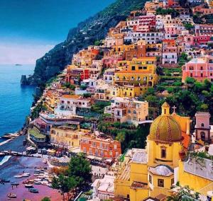 a group of buildings on a hill next to the ocean at Holiday House D' Anna 68 in Agerola