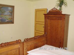 a bedroom with a wooden bed and a wooden dresser at Petrovický mlýn in Kasanice