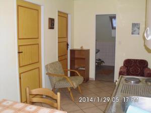 a living room with a table and chairs and a room at Petrovický mlýn in Kasanice
