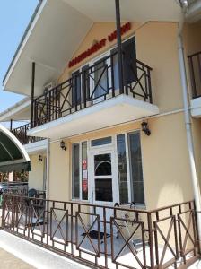 a house with a balcony with a balcony at Apartment Ureki in Ureki