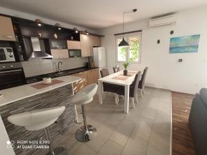 a kitchen and dining room with a table and chairs at Apartment Glavica in Goveđari