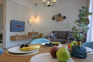 a dining room table with bananas and fruit on plates at Under the Aqueduct boutique house in Kavála