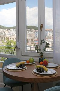 a wooden table with fruit on top of a window at Under the Aqueduct boutique house in Kavála