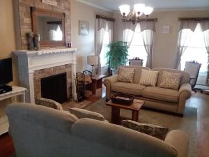 a living room with two couches and a fireplace at Splendor Inn Bed & Breakfast in Norwich