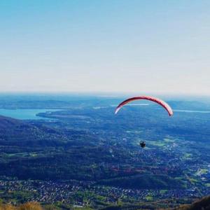 a person in a parachute flying over a city at Il Castello in Nebbiuno