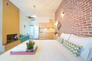 a living room with a brick wall at Golden Beachside terrace in Chrysi Ammoudia