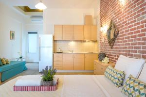 a kitchen and living room with a brick wall at Golden Beachside terrace in Chrysi Ammoudia