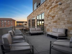 a patio with chairs and couches on a building at Hyatt Place Amarillo-West in Amarillo