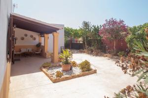 a courtyard with potted plants and a building at Can Moya in San Ferrán de ses Roques