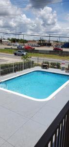 a swimming pool on a balcony with a fence at Econo Lodge San Antonio Northeast I-35 in San Antonio
