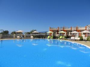 a large blue swimming pool with buildings in the background at Nice Home Pizzo in Pizzo