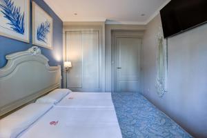 Postel nebo postele na pokoji v ubytování Hotel Rosa