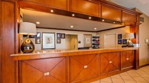 a bar in a home with wood paneling at Best Western Plus Bessemer in Bessemer