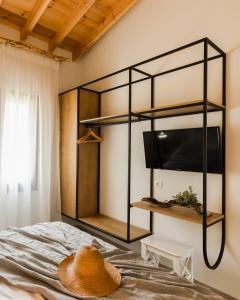 a bedroom with a bed with a hat on it at Mystes in Samothráki