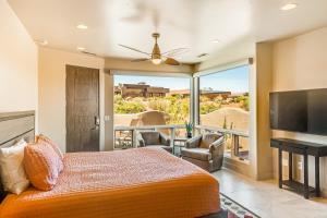 a bedroom with a bed and a large window at Entrada Casita with a View in St. George