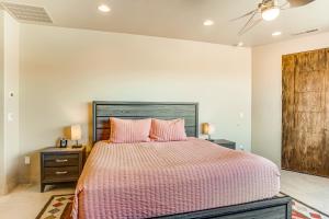 a bedroom with a large bed with pink pillows at Entrada Casita with a View in St. George