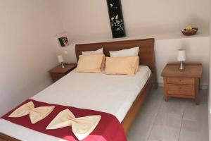 a bedroom with a large bed with two night stands at Panorama View Apartment 2 in Áyioi Apóstoloi +12 photos