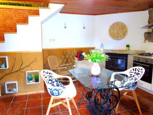 a dining room with a glass table and chairs at Casa da Carvalheira in Parada