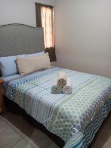 a stuffed animal sitting on top of a bed at Canela Apartment, Pet friendly in Puerto Peñasco