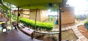 a porch with a bench and an umbrella at Kohchang 7 Guest House in Ko Chang