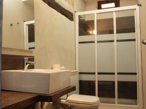 a bathroom with a sink and a toilet at La Posada de Grimaldo in Grimaldo