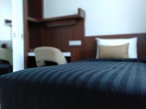 Postel nebo postele na pokoji v ubytování UTM Hotel & Residence