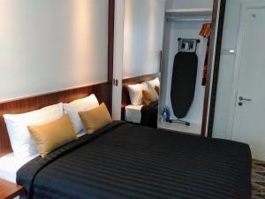 Postel nebo postele na pokoji v ubytování UTM Hotel & Residence