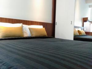 Postel nebo postele na pokoji v ubytování UTM Hotel & Residence