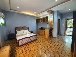 a bedroom with a bed and a desk in it at Ralphseej Pension House in Moalboal