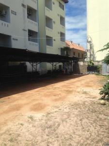 an empty parking lot in front of a building at Baan Talay in Pattaya South