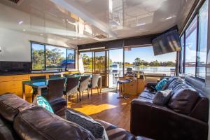 a living room with a couch and a table at All Seasons Houseboats in Mildura