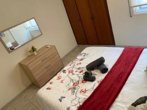 a bedroom with a bed with a camera on it at City Comfortable Apartment in Larnaca