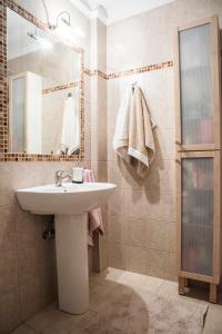 a bathroom with a sink and a mirror at Eirinis House in Possidi