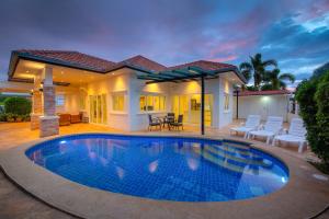 a swimming pool in front of a house at Orchid Paradise Homes Villa in Hua Hin +6 photos