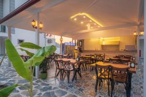 a restaurant with tables and chairs in a room at The Monastery in Oludeniz