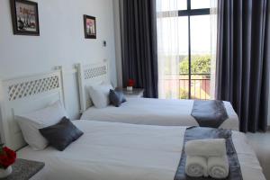 Ένα ή περισσότερα κρεβάτια σε δωμάτιο στο Royal Ushaka Hotel Morningside +6 φωτογραφίες