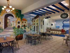 a restaurant with tables and chairs and a mural at 蓋雅之都民宿 民宿編號1468號 in Taitung City