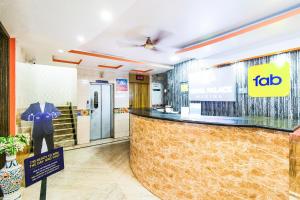 a tlc store with a suit on a mannequin at Royal Palace Marina in Chennai