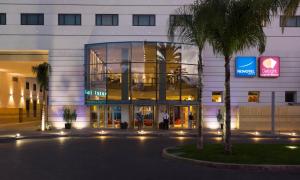 a large building with a large window in front of it at Novotel Casablanca City Center in Casablanca