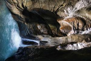 an aerial view of a waterfall in a cave at Alpenrose in Innertkirchen