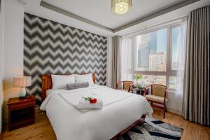 Postel nebo postele na pokoji v ubytování Ace Hotel Ben Thanh