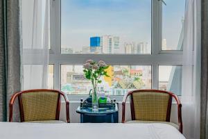 Postel nebo postele na pokoji v ubytování Ace Hotel Ben Thanh