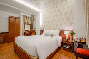 Postel nebo postele na pokoji v ubytování Ace Hotel Ben Thanh